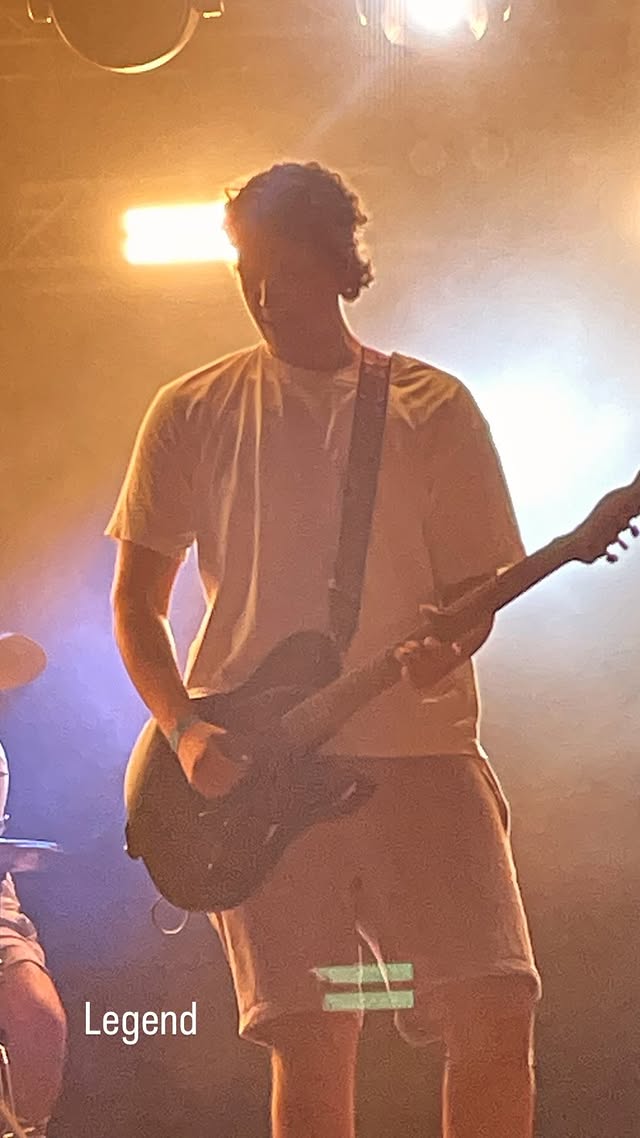 Ian Storm performing under blue stage lights